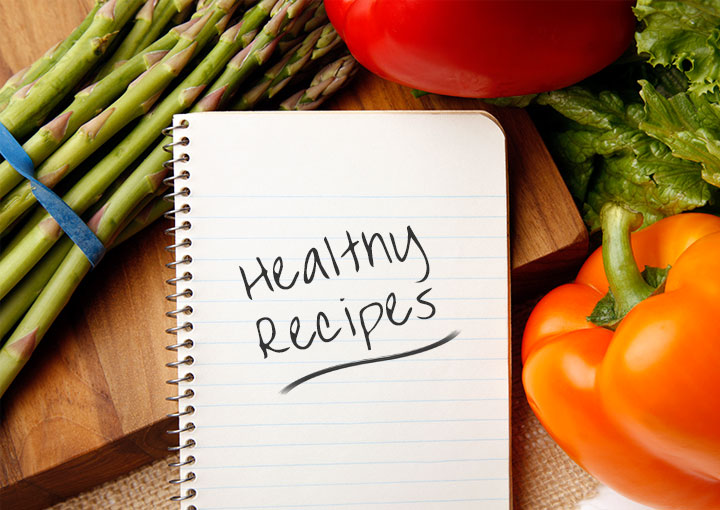 recipe-of-the-month-pic Healthy recipes notepad surrounded by vegetables and a cutting board.